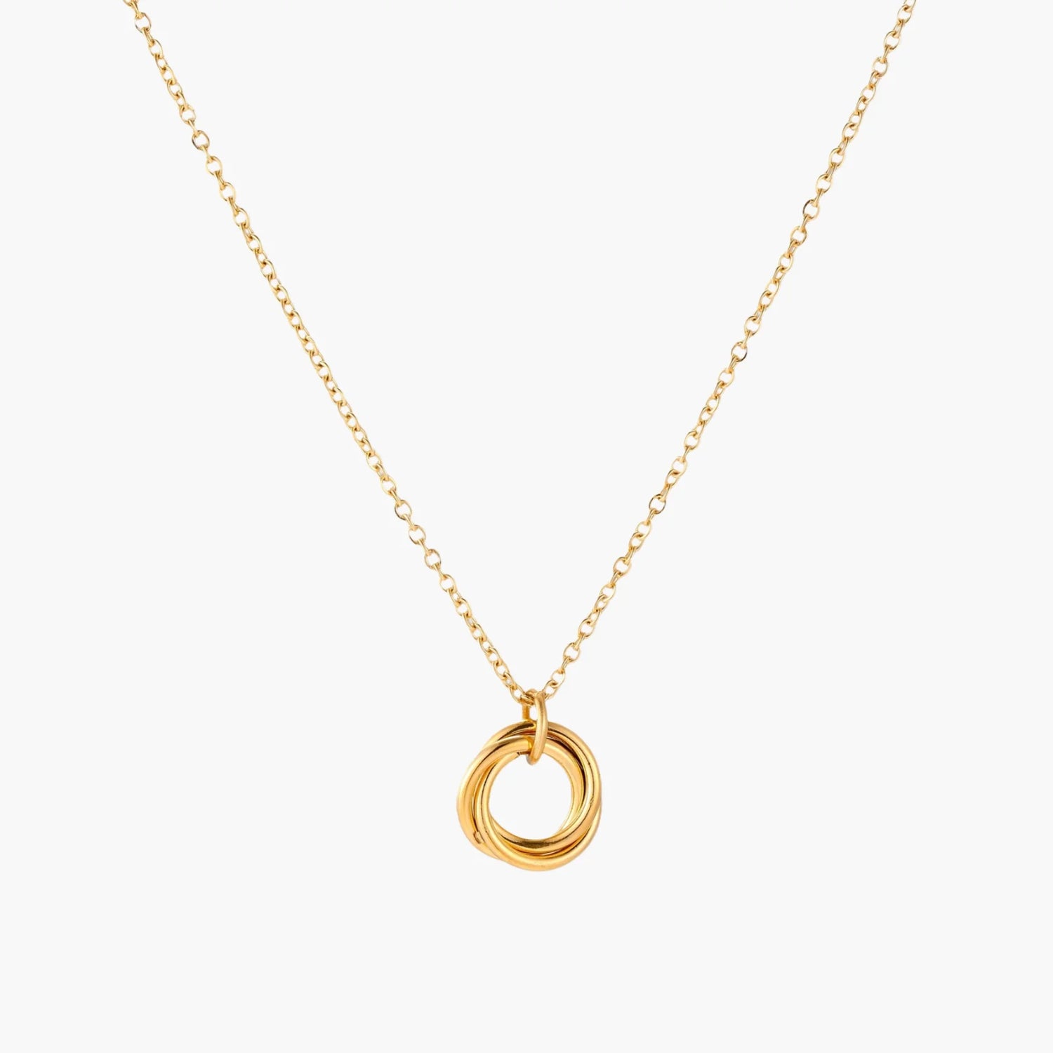 Delicate gold-plated necklace with three interlocking circle rings forming a minimalist knot pendant on cream background