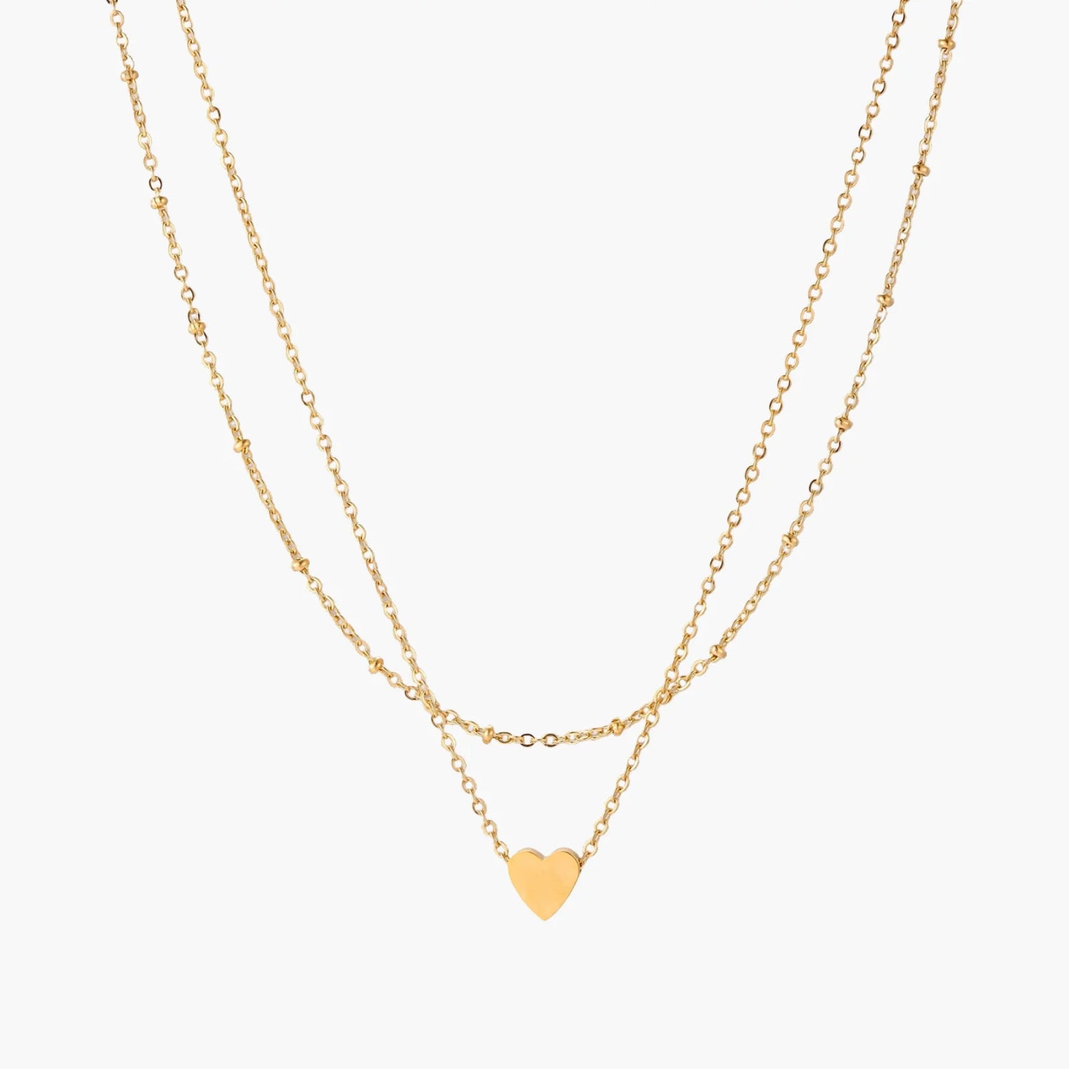 Delicate double-chain gold necklace with tiny heart pendant on cream background