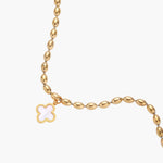 18K gold-plated oval bead chain bracelet with quatrefoil clover charm featuring mother of pearl inlay on cream background
