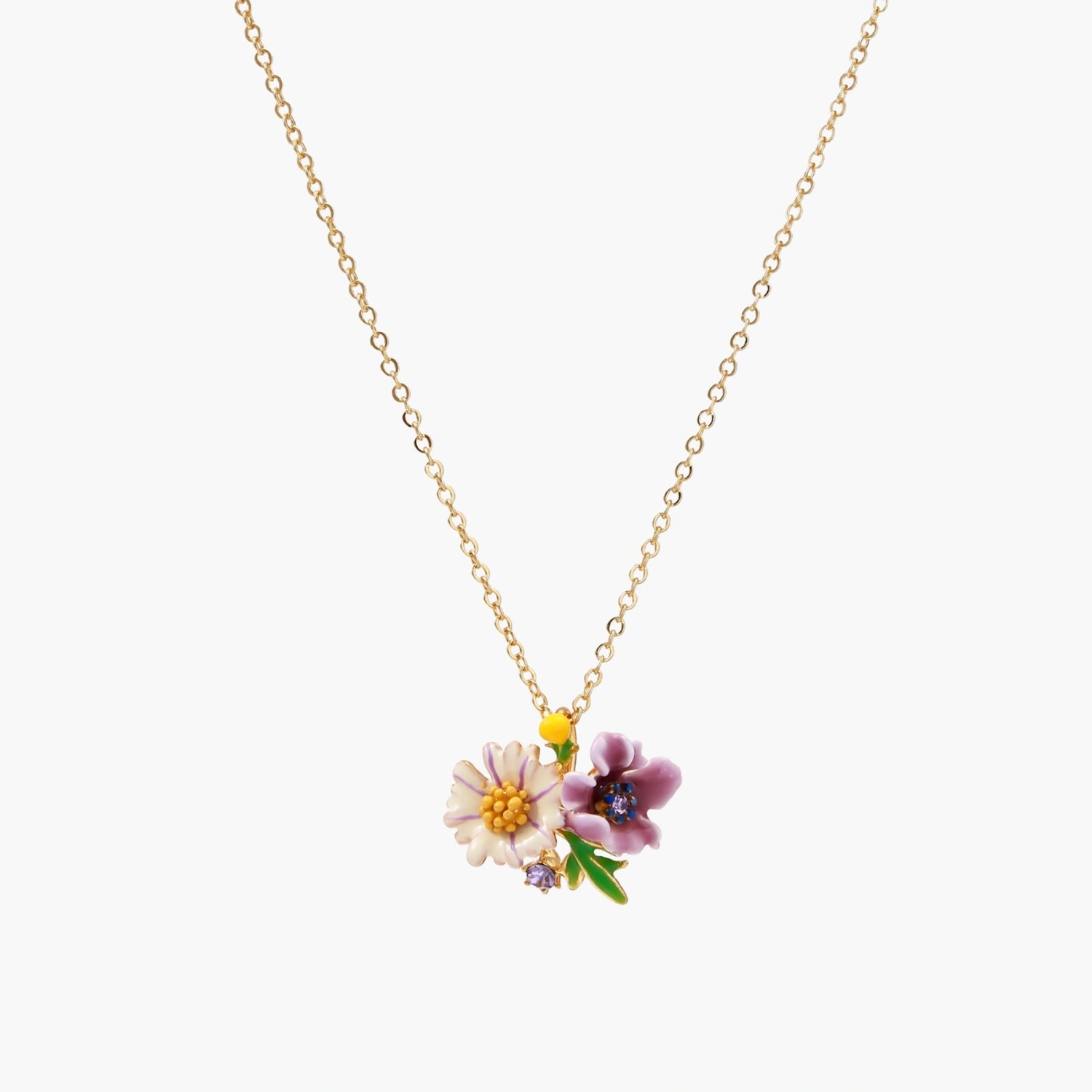 Gold-plated necklace with pink and purple enamel flower pendant featuring crystal accents on cream background