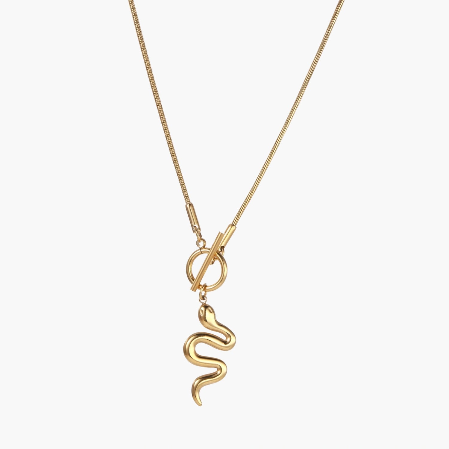 Sculptural gold snake pendant on delicate chain with toggle clasp, featuring smooth curves and polished 14K gold plated finish