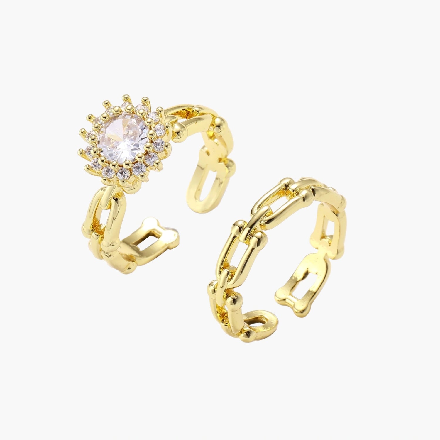 Two adjustable gold rings: chain-link band and halo-style ring with cubic zirconia stones on cream background